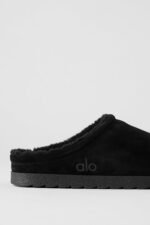 Alo Recovery Slipper in the black suede color with a faux fur lining.  - Image 2