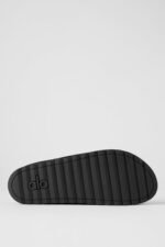 Alo Recovery Slipper in the black suede color with a faux fur lining.  - Image 4